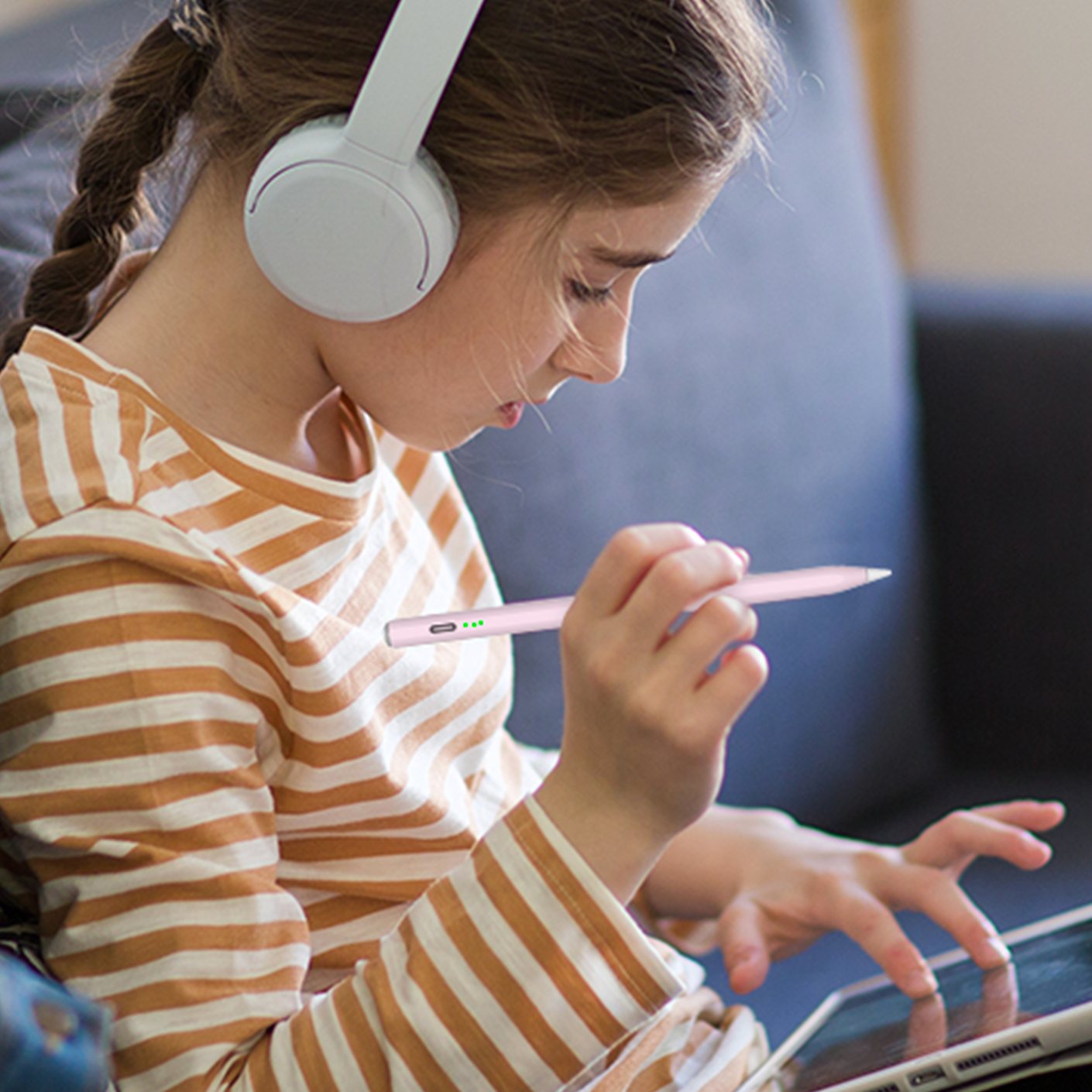 A girl drawing on a tablet with the pink OASO disc tip stylus